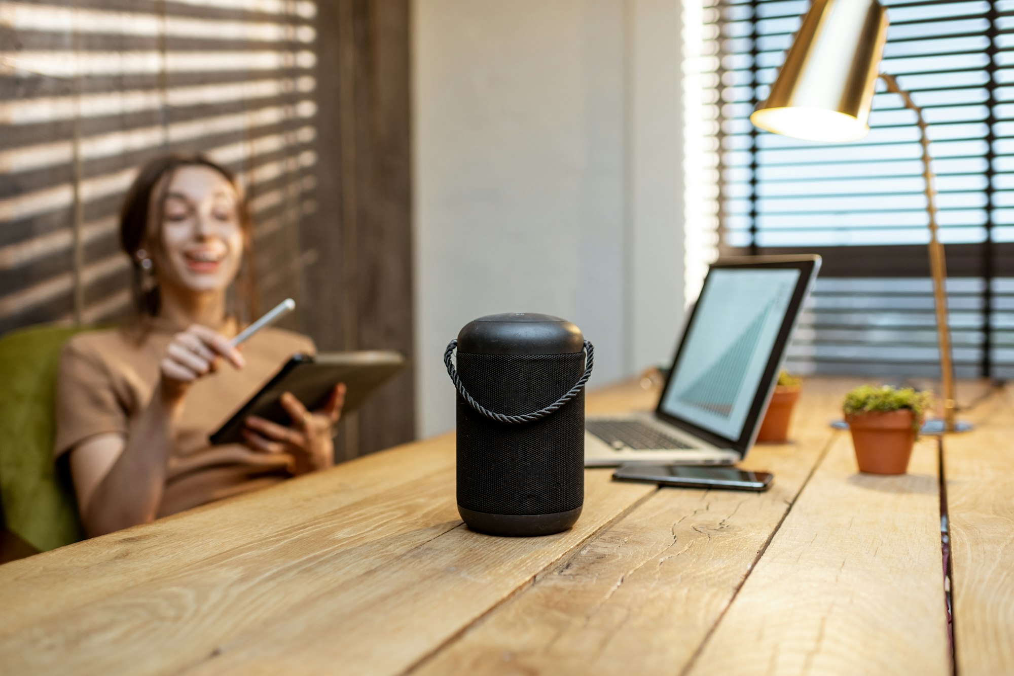 Woman talking to the smart speaker indoors